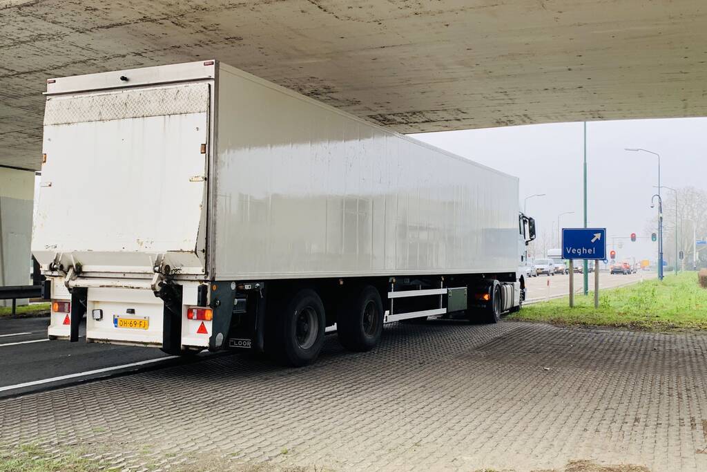 Auto belandtt in bosschages na aanrijding met vrachtwagen