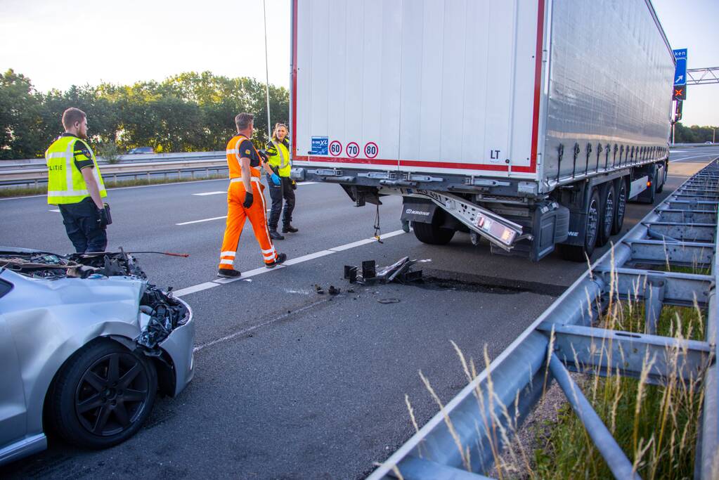 Auto schiet onder oplegger vrachtwagen