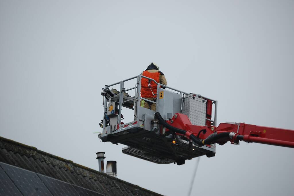 Brandweer blust brand in schoorsteen