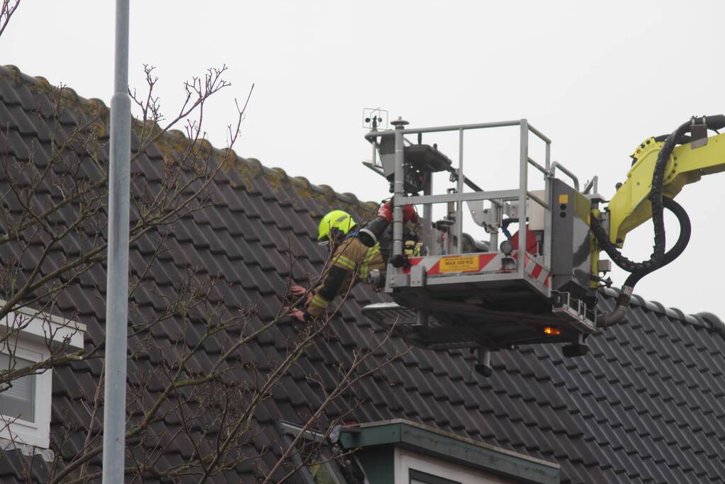 Brandweer zet loszittende dakpannen vast