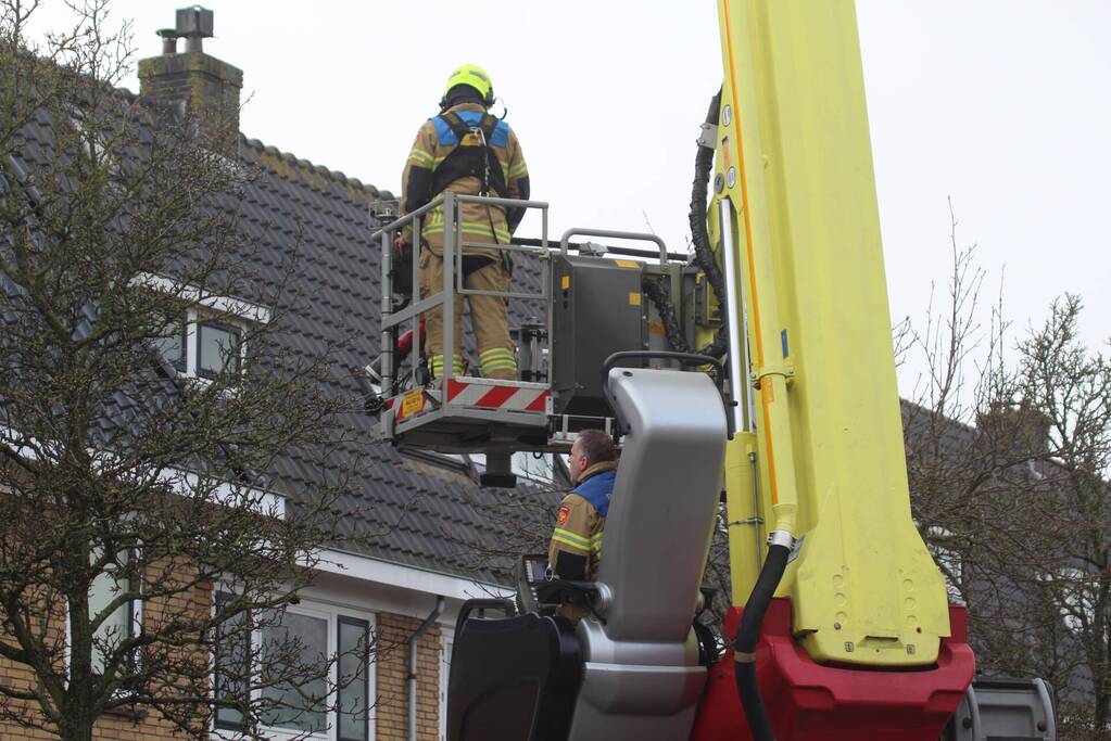 Brandweer zet loszittende dakpannen vast