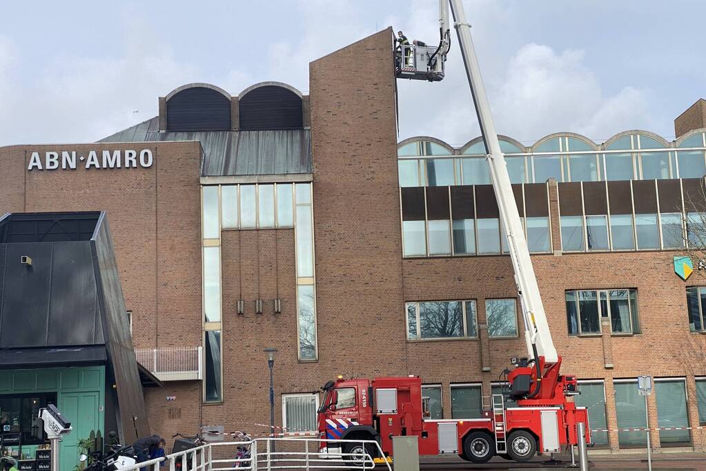 Brandweer verwijderd losgekomen dakbedekking