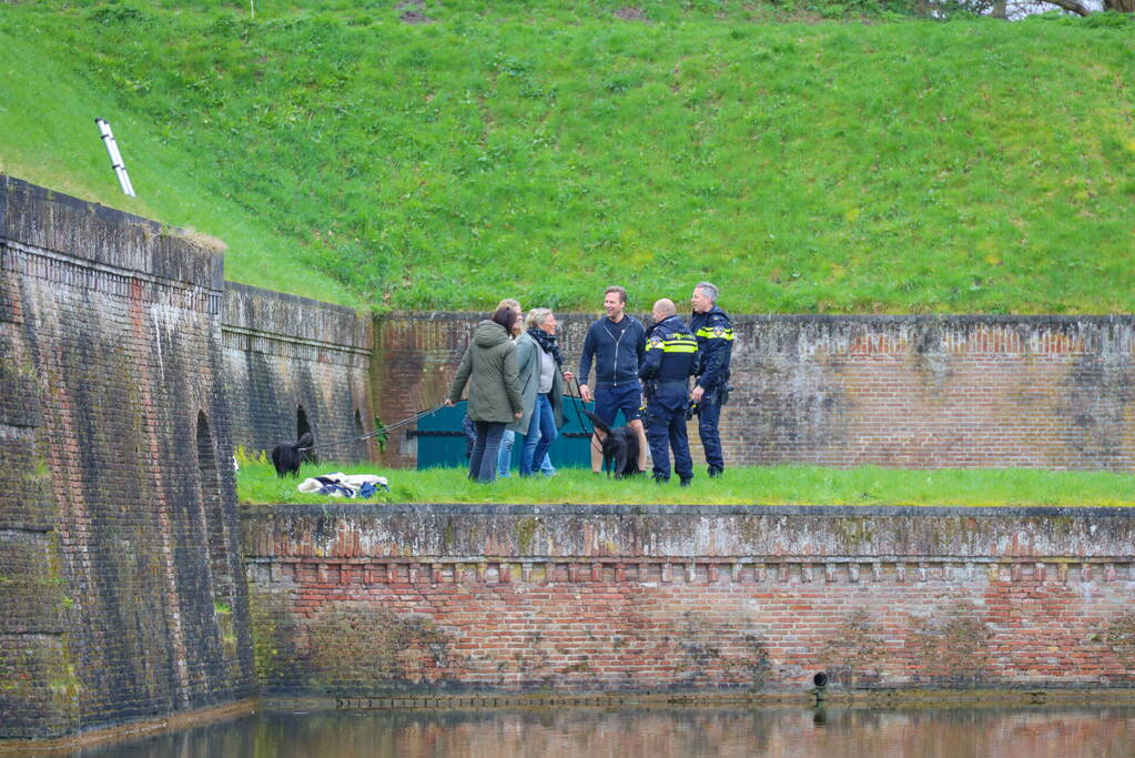 Hond valt van meters hoge vestingwal in water