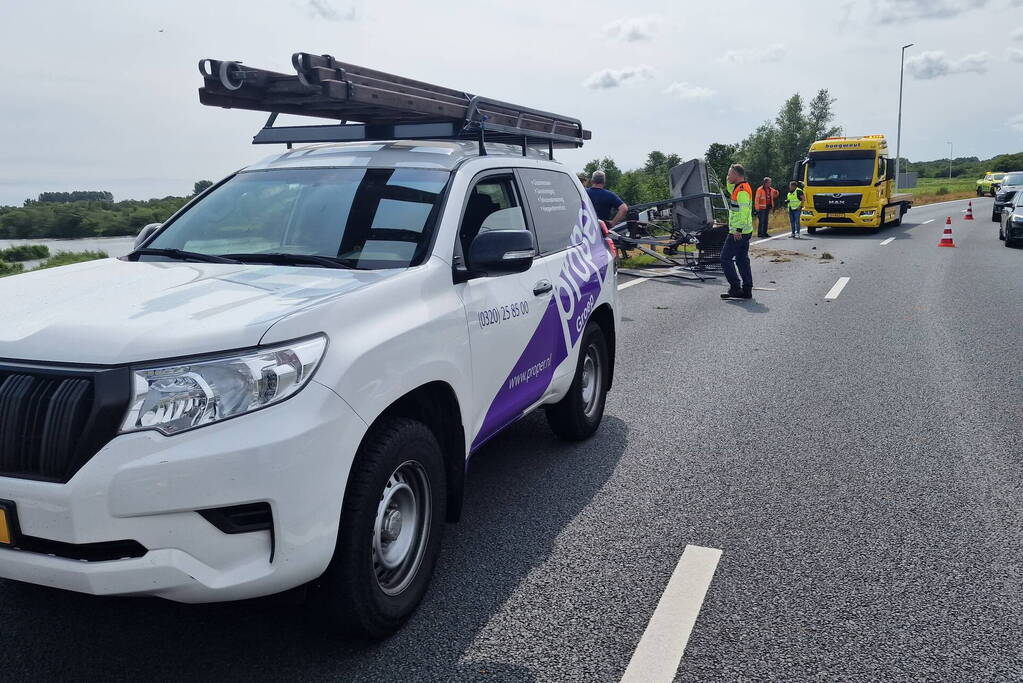 Auto met hoogwerker botst op vangrail