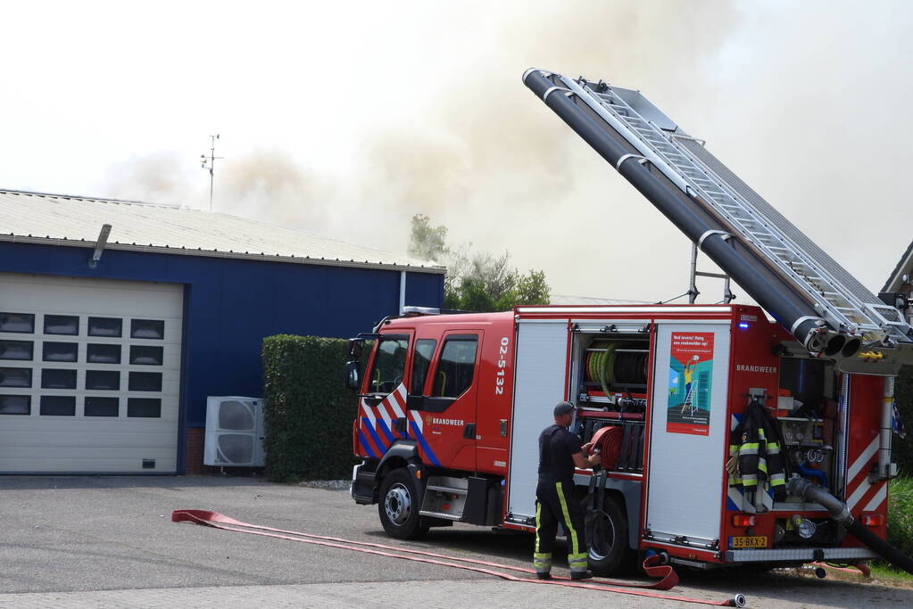 Grote brand in loods met komkommers en paprika's