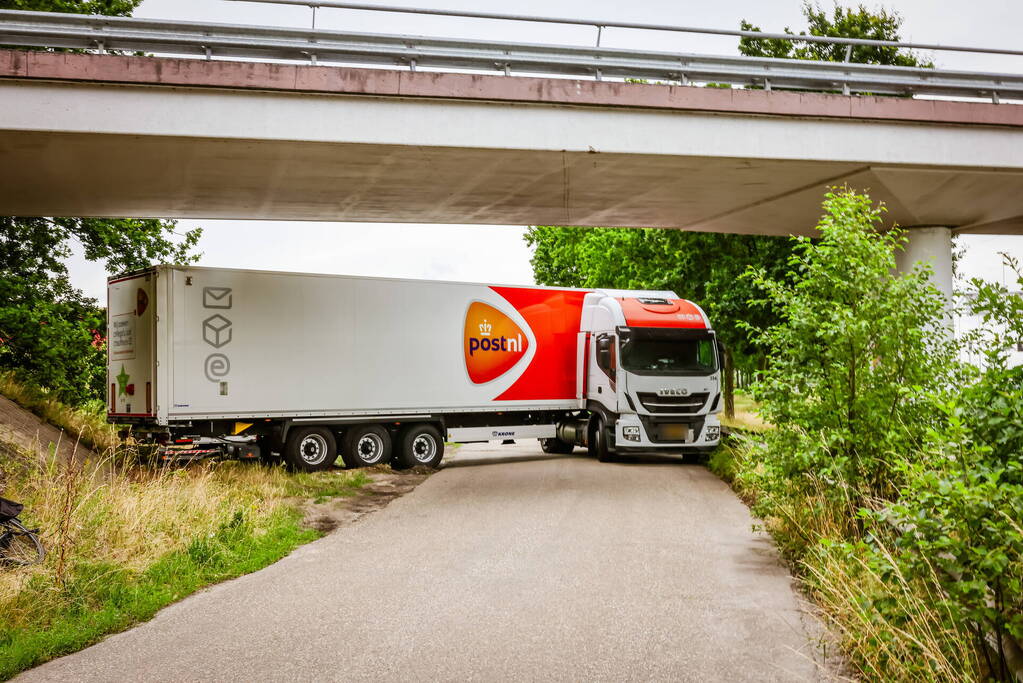 Vrachtwagenchauffeur rijdt zich vast na het keren