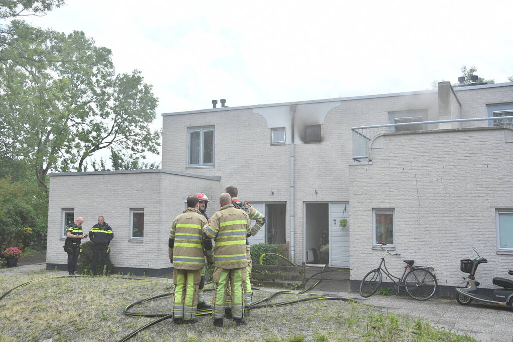 Zwarte rook uit woning door brand