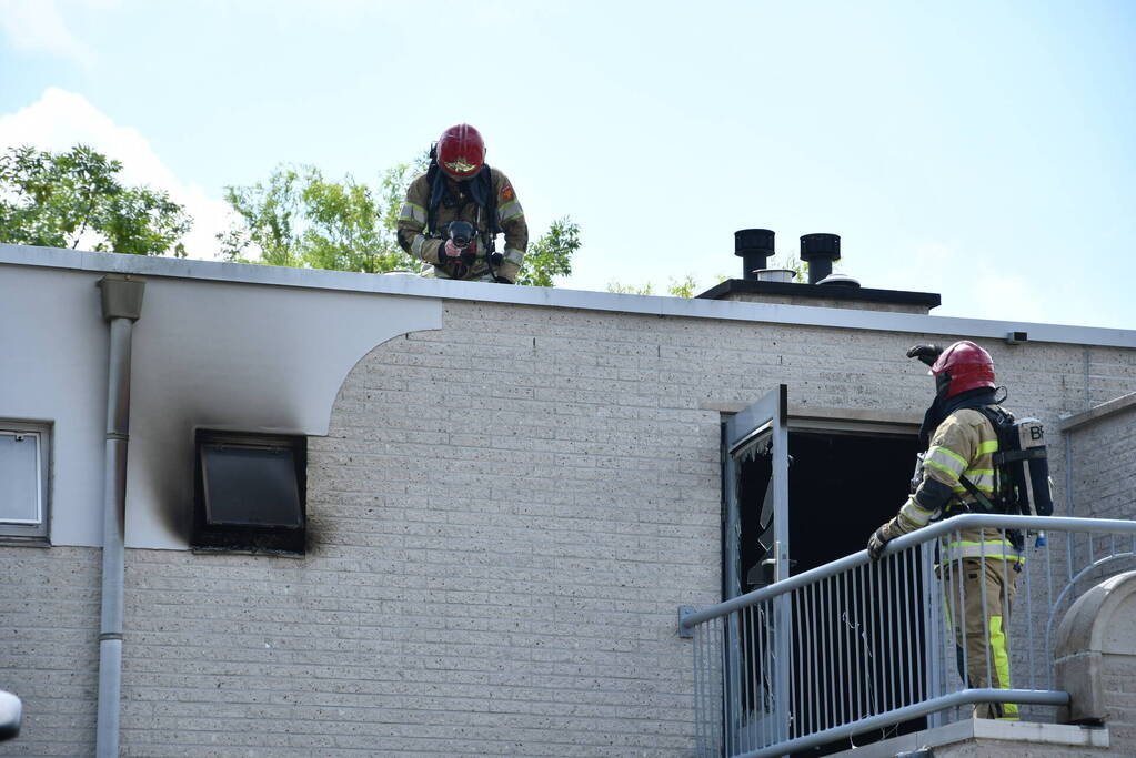 Zwarte rook uit woning door brand