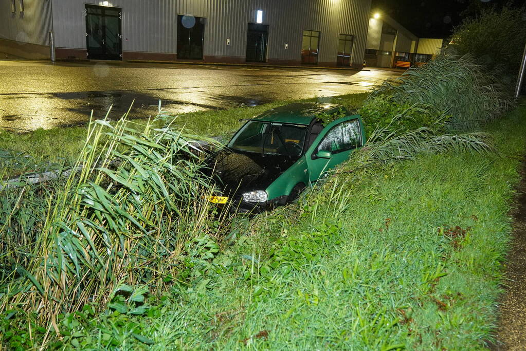 Auto glijdt de bocht uit in een sloot