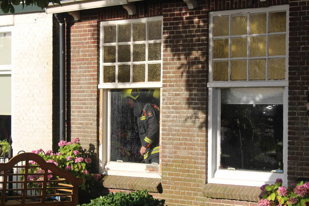 Brand tussen de muur van woningen