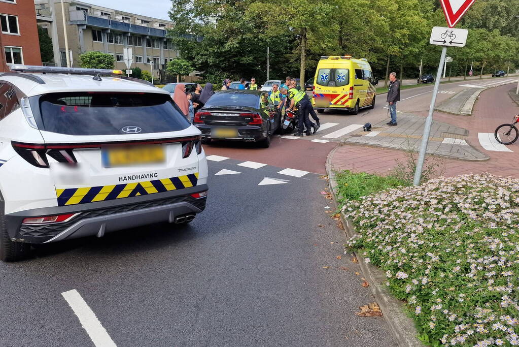 Automobilist en scooterrijder in botsing op rotonde