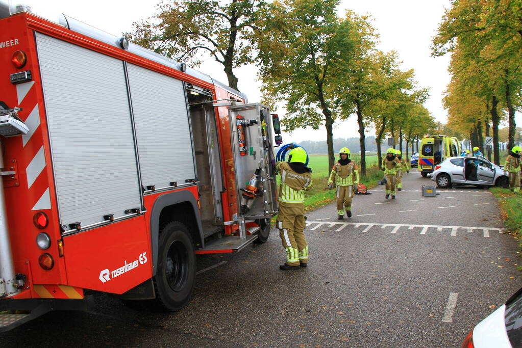 Bestuurder bekneld bij botsing tegen boom