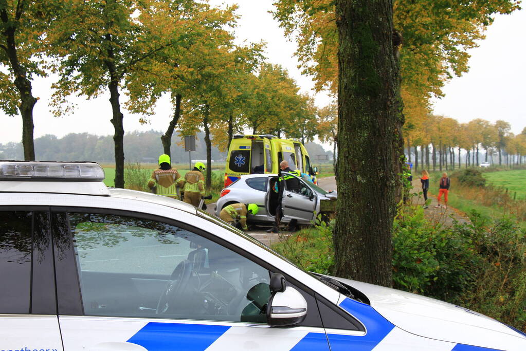 Bestuurder bekneld bij botsing tegen boom