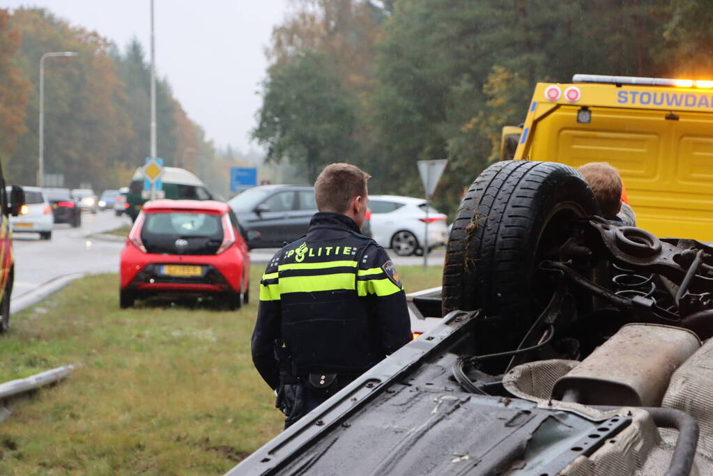 Auto vliegt over vangrail en belandt op kop