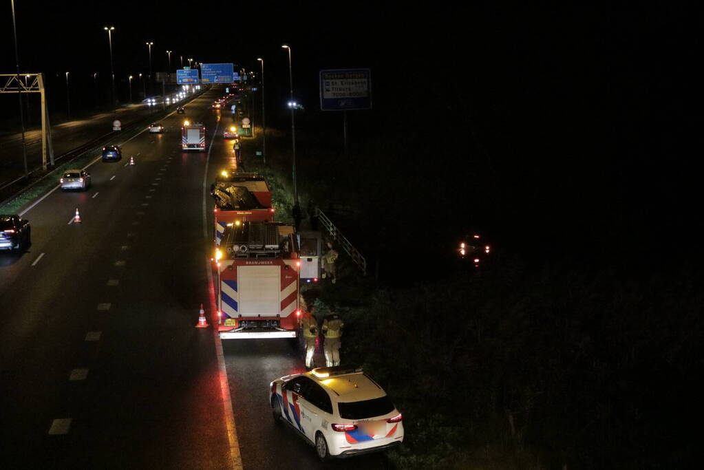 Auto belandt in water naast snelweg