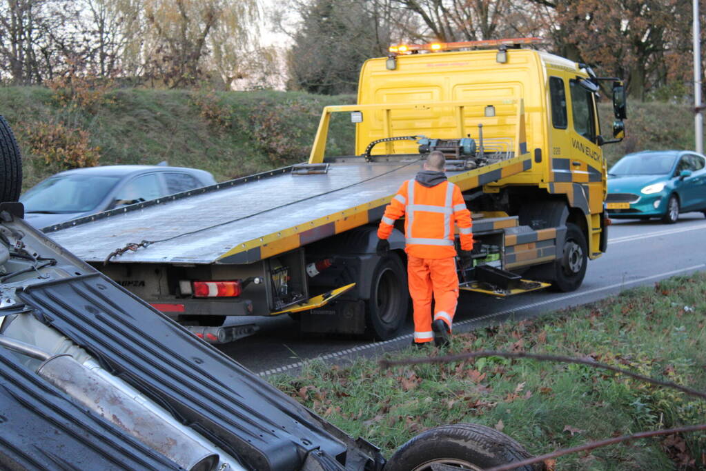 Auto op zijn kop na aanrijding met vrachtwagen