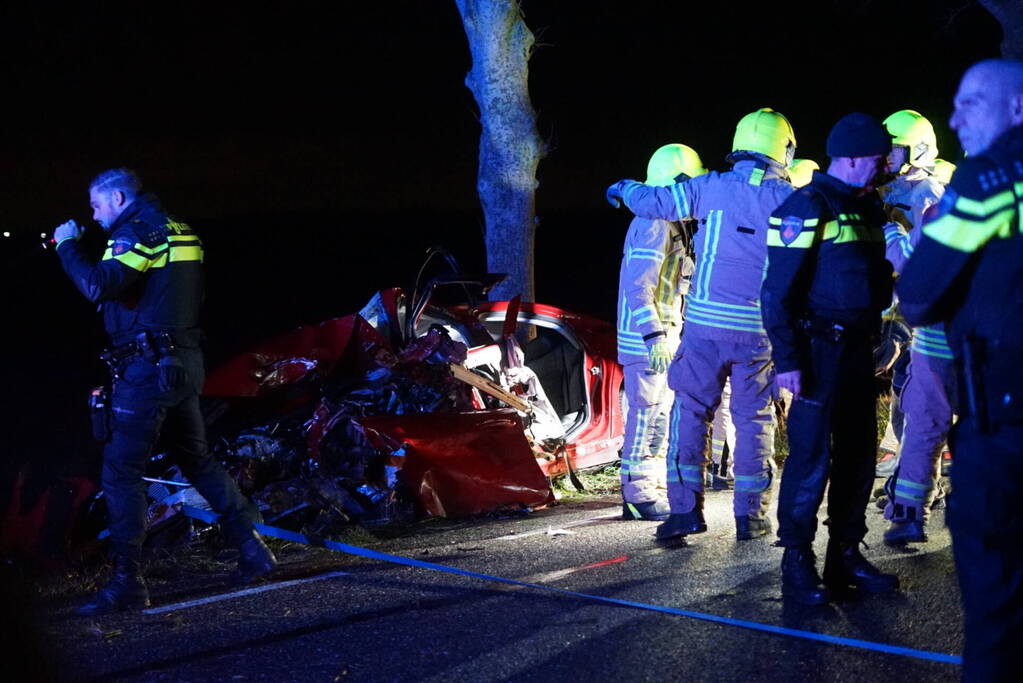 Auto zwaar beschadigd na frontale botsing tegen boom, bestuurder zwaargewond