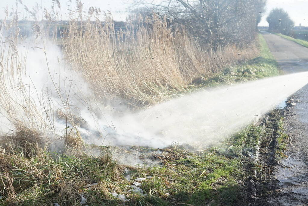 Brandweer blust brand in berm