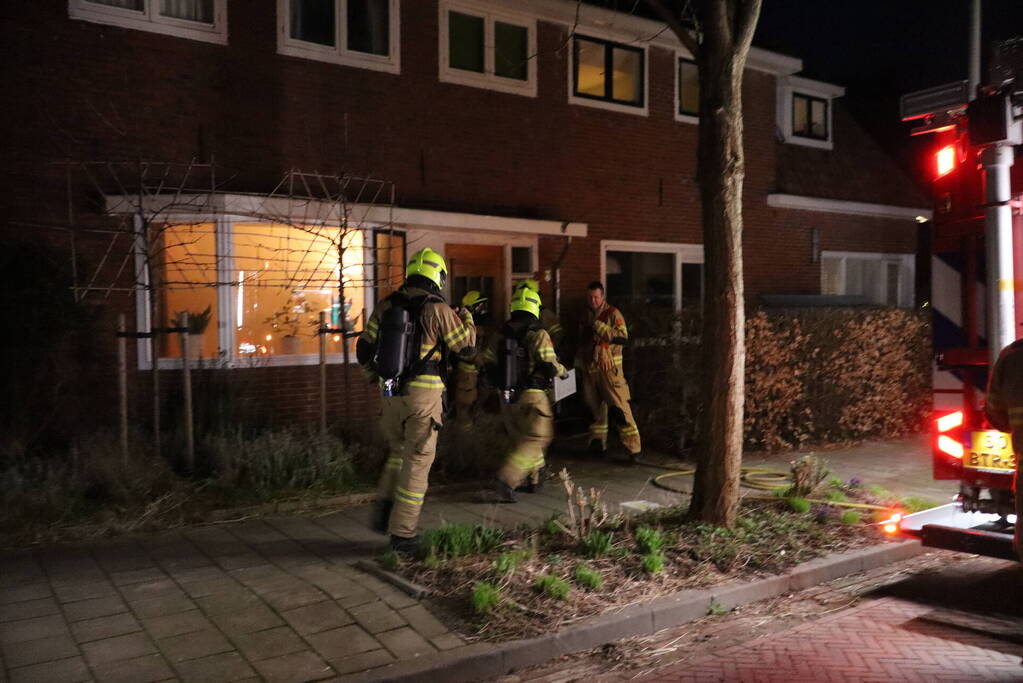 Rook in woning door smeulend hout op kachel