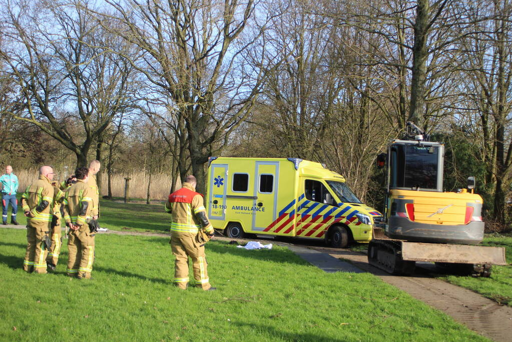 Vastgereden ambulance losgetrokken door graafmachine