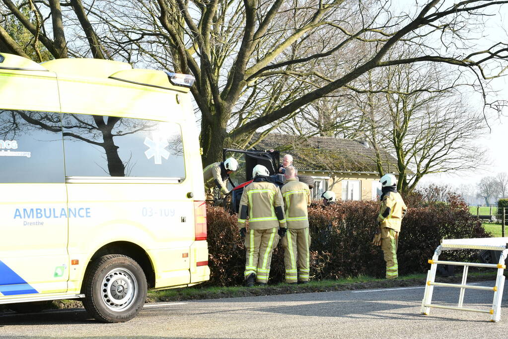 Auto raakt van de weg en belandt op zijkant in voortuin