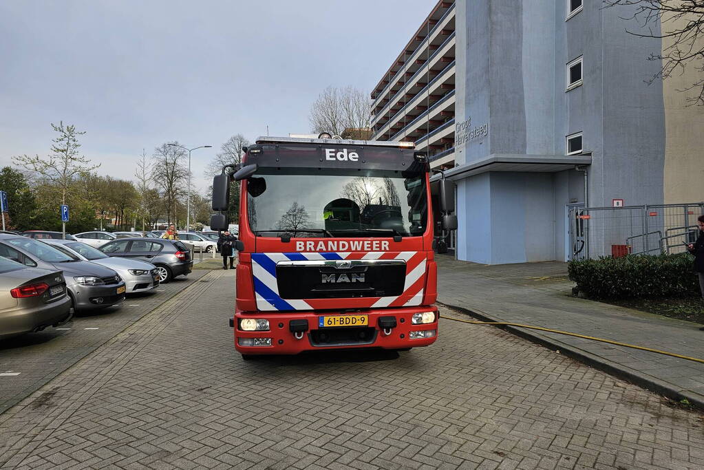 Motor in brand naast flatgebouw