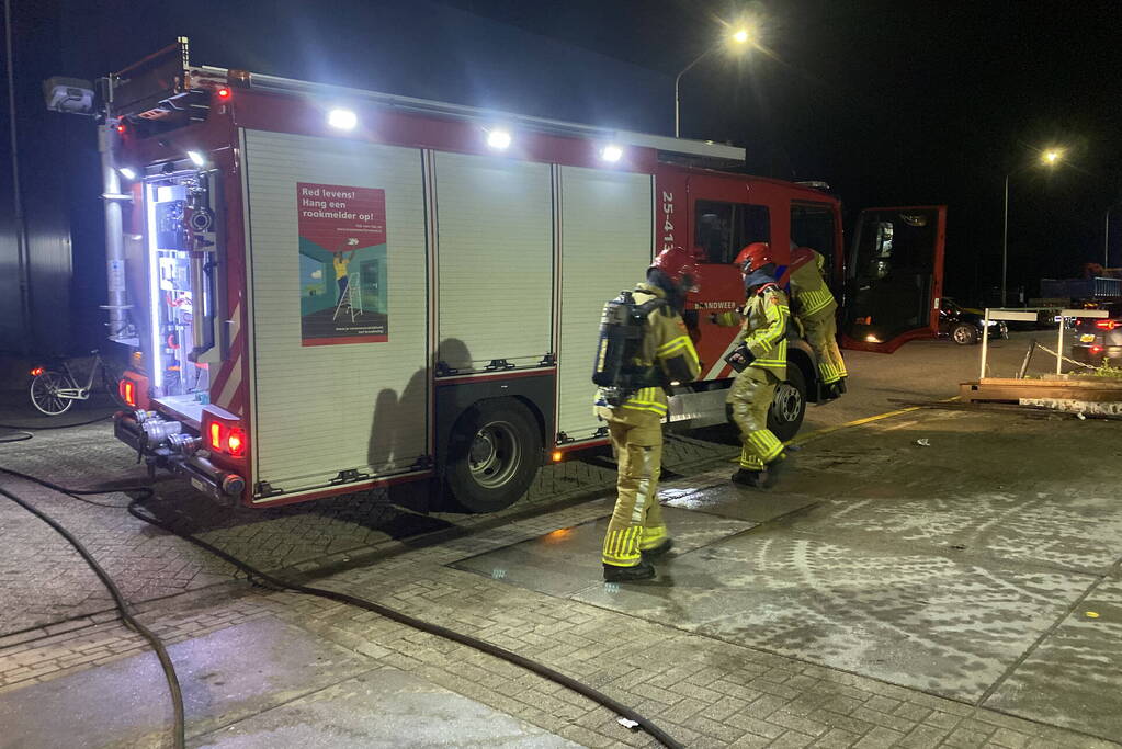 Brandweer blust brandende pallets