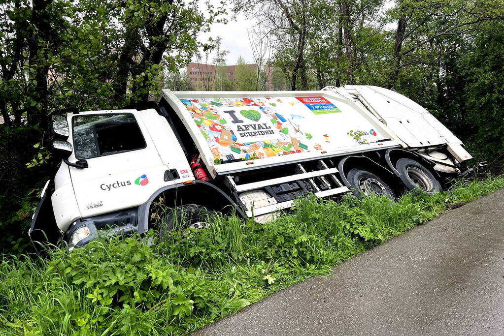 Vuilniswagen glijdt de bosschages in