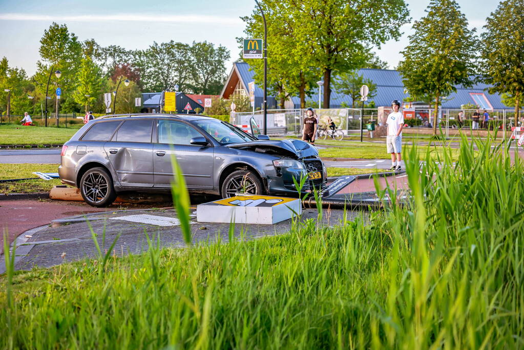 Automobilist vliegt over de rotonde botst op lantaarnpaal