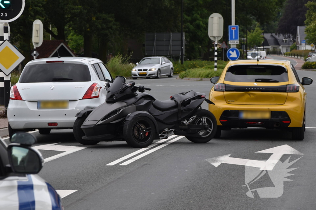 Driewiel motor rijder botst achterop twee auto's