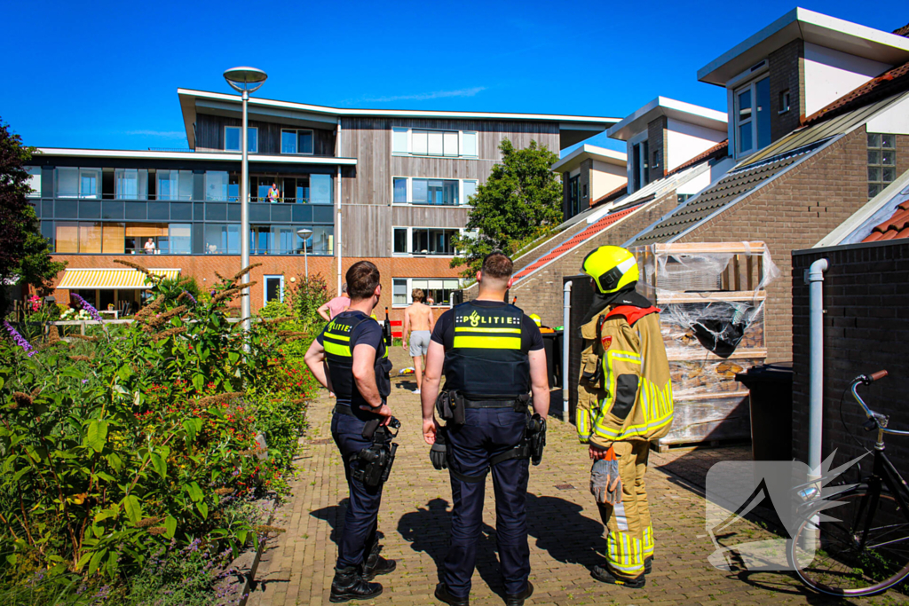 Afvalbak vat vlam bij woning