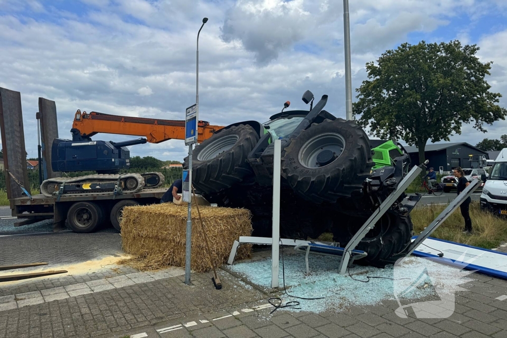 Trekker raakt van de weg en kantelt op bushokje