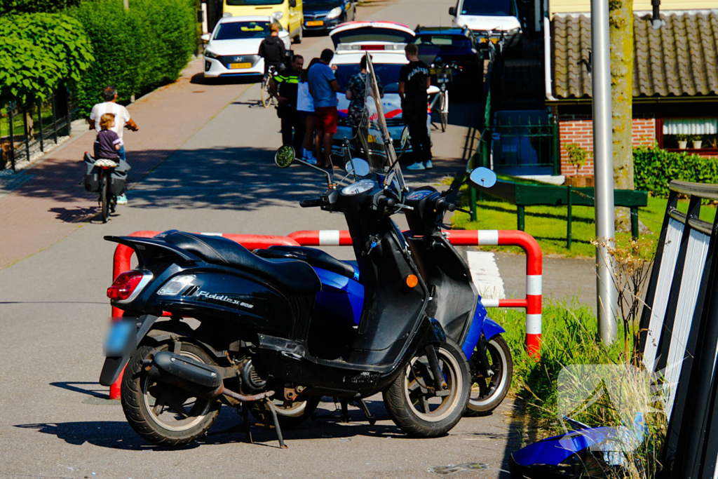 Twee scooterrijders botsen op elkaar