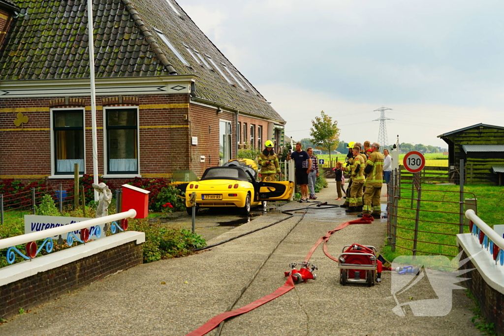 Personenwagen naast woning vliegt in brand