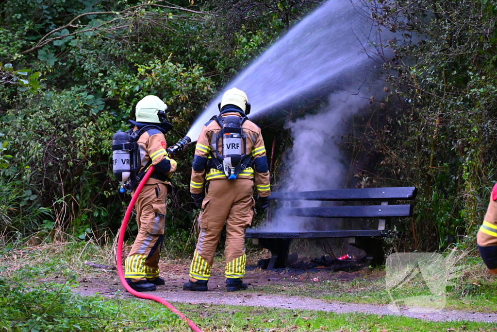 Brandweer blust brandende houten bank