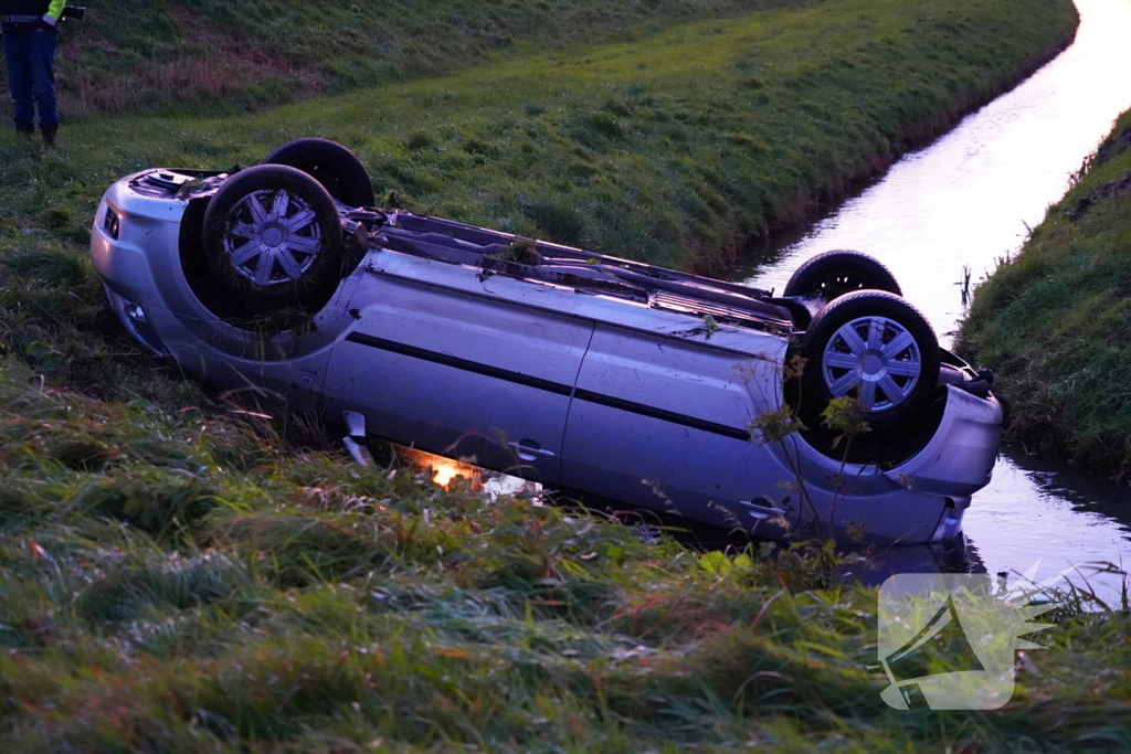 Brandweer haalt persoon uit auto in sloot