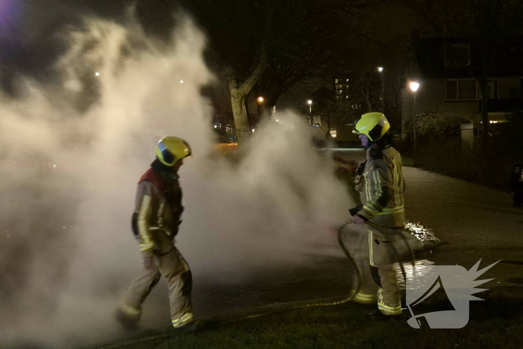 Brandweer blust afvalbrand op straat