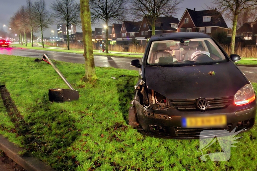 Auto vliegt uit de bocht en rijdt lichtmast uit de grond