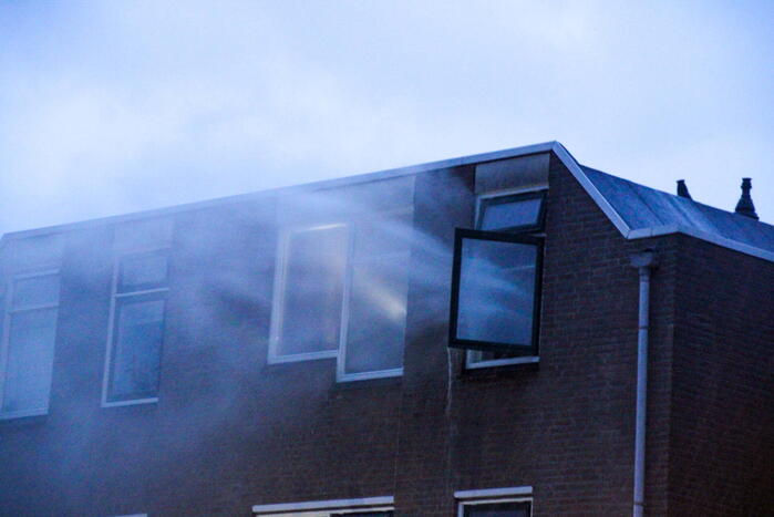 Brand in woning, persoon aangehouden