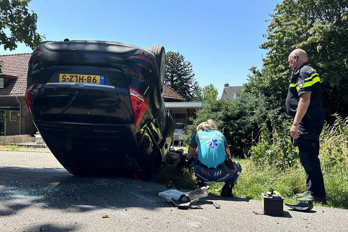 Auto belandt op de kop na botsing tegen boom