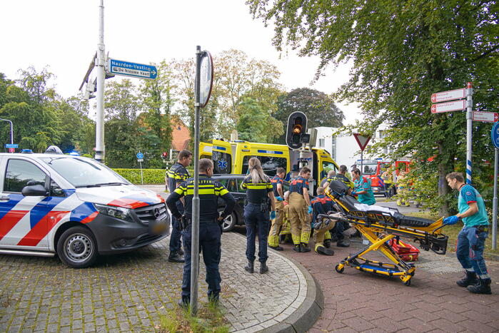 Fietser bekneld tussen auto en paal