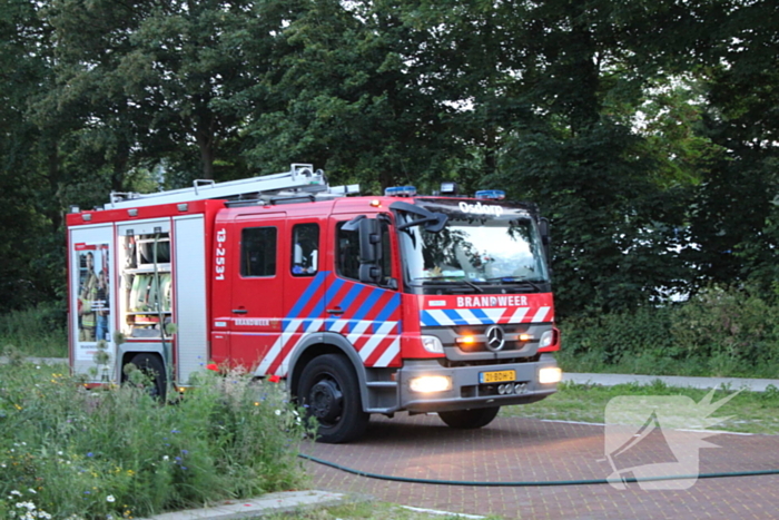 Brandweer blust brand in geparkeerde auto