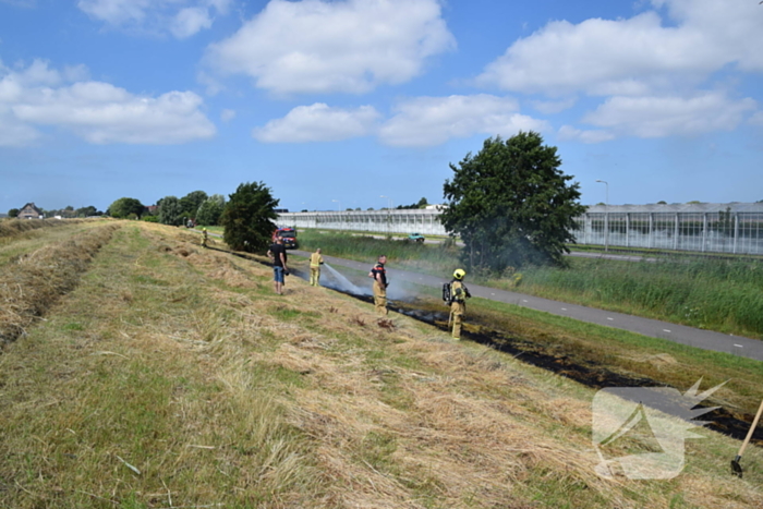 Tientallen meters berm in brand