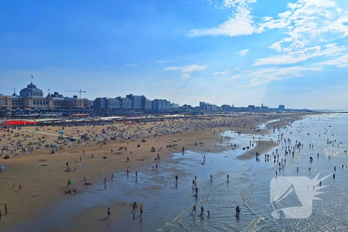 Mensen zoeken verkoeling op het strand