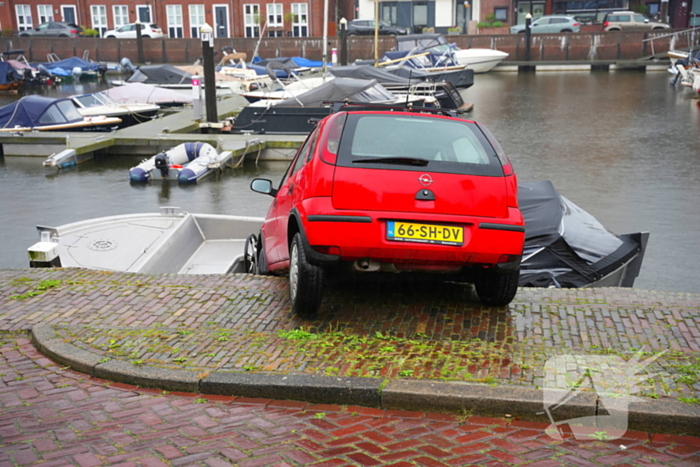 Auto rolt tegen boot aan