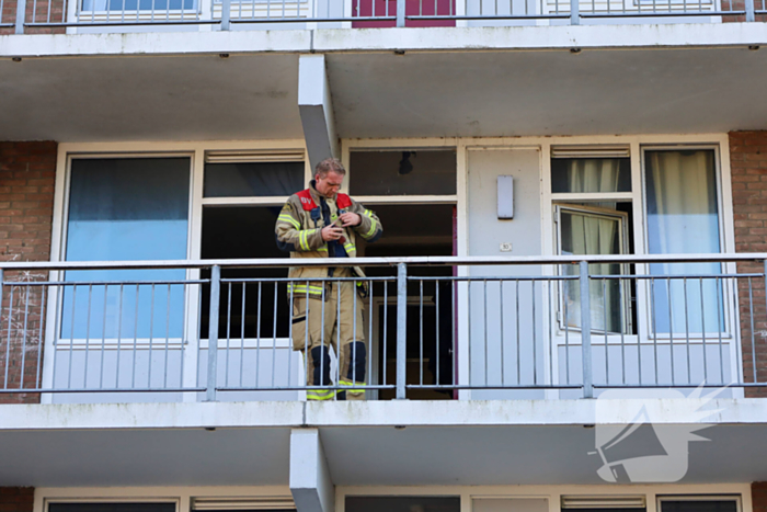 Brandweer ramt deur open wegens brand in flatwoning