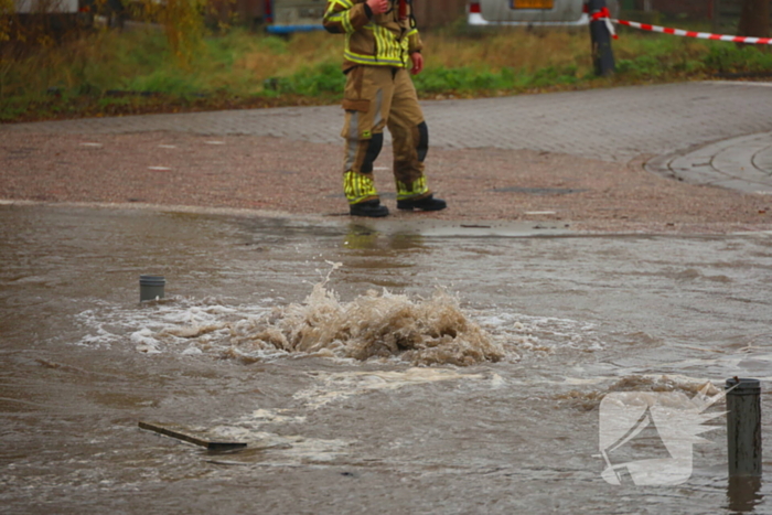 Straat onder water gelopen door kapotte waterleiding